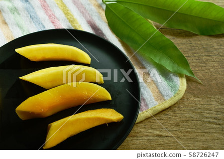 Barracuda mango tropical fruit sweet taste slice on plate Barracuda mango tropical fruit sweet taste slice on plate 58726247