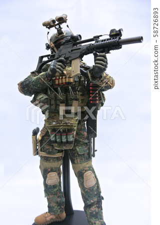 Selected focused of modern army action figure complete with uniform, battle gear and weapon. Collector item action figure with very high detail.  58726893