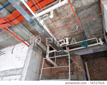 Electrical conduit, cable tray and aircond pipes as part of services above ceiling installed at the construction. Electrical conduit, cable tray and aircond pipes as part of services above ceiling installed at the construction. 58727028