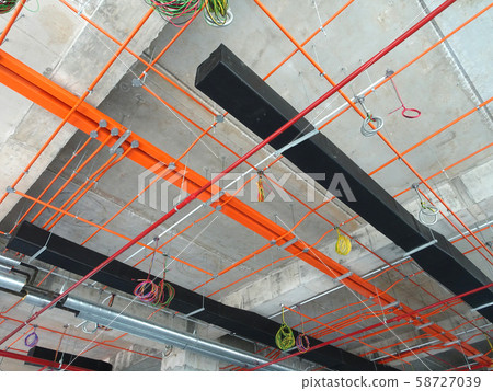 Electrical conduit, cable tray and aircond pipes as part of services above ceiling installed at the construction.  58727039