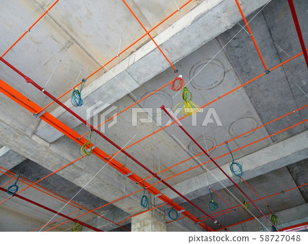 Electrical conduit, cable tray and aircond pipes as part of services above ceiling installed at the construction.  58727048