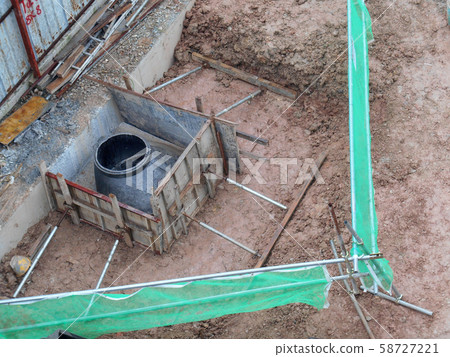 Underground drainage manhole under construction by construction workers at the construction site. The manhole design based on infrastructure engineer design. Underground drainage manhole under construction by construction workers at the construction site. The manhole design based on infrastructure engineer design. 58727221