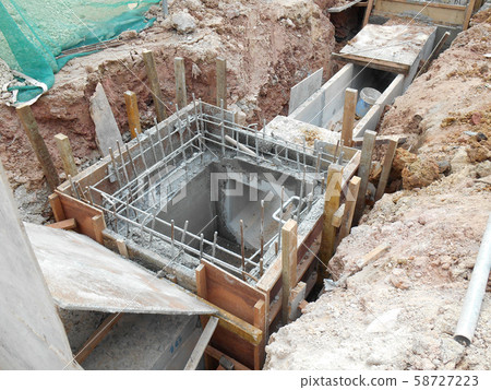 Underground drainage manhole under construction by construction workers at the construction site. The manhole design based on infrastructure engineer design. Underground drainage manhole under construction by construction workers at the construction site. The manhole design based on infrastructure engineer design. 58727223