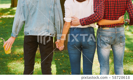polyamorous relationship woman standing two guys 58728618