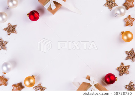 Christmas and New Year holiday composition. Mock up frame with gift box, balls and stars on white Christmas and New Year holiday composition. Mock up frame with gift box, balls and stars on white 58728780
