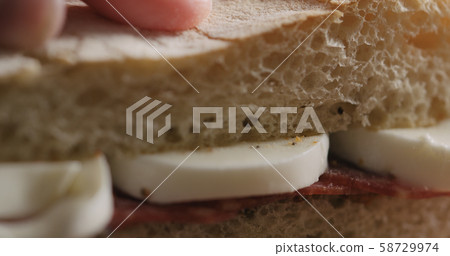 Extreme closeup put top on slami mozzarella sandwich Extreme closeup put top on slami mozzarella sandwich 58729974