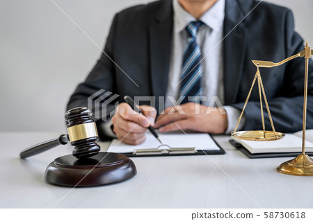 Male lawyer or judge working with contract papers, 58730618