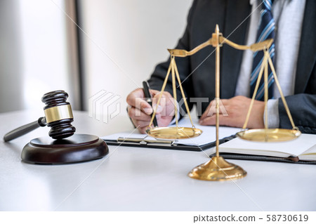 Male lawyer or judge working with contract papers, 58730619