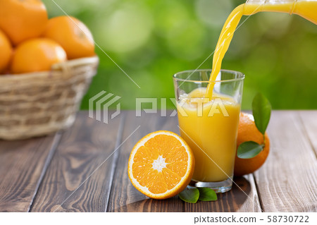 orange juice pouring in glass orange juice pouring in glass 58730722