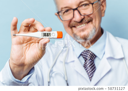 Portrait of a handsome senior doctor holding a thermometer in his hands, on a thermometer, the Portrait of a handsome senior doctor holding a thermometer in his hands, on a thermometer, the 58731127