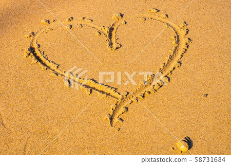 Heart drawn in the sand. Beach background. Top view. Love concept Heart drawn in the sand. Beach background. Top view. Love concept 58731684