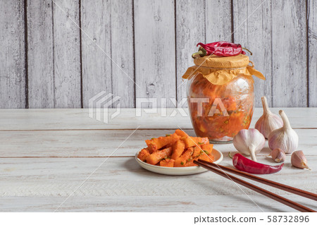 Kimchi pumpkin pickles on a wooden background. 58732896