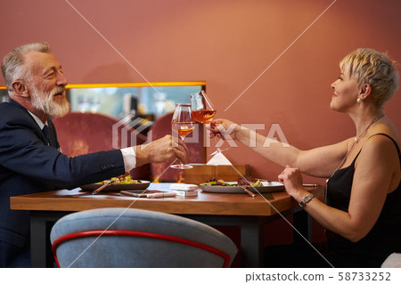 Mature couple having dinner together at restaurant Mature couple having dinner together at restaurant 58733252
