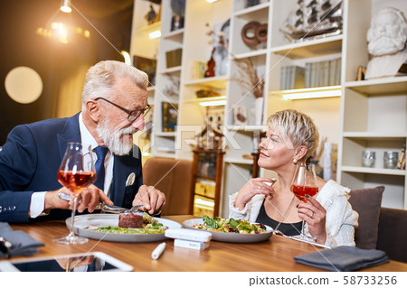 Mature married couple fine dining food in elegant restaurant Mature married couple fine dining food in elegant restaurant 58733256