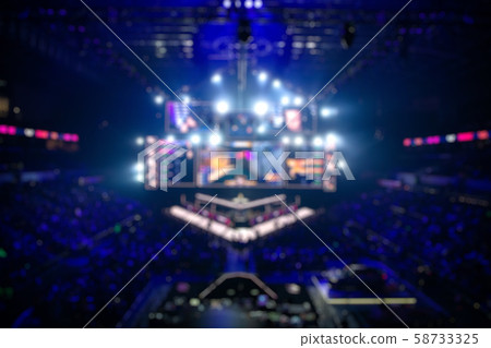 Blurred background of an esports event - Big illuminated main stage of a computer games tournament 58733325