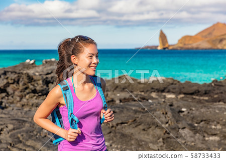 Galapagos tourist on Santiago Island in Galapagos Islands Galapagos tourist on Santiago Island in Galapagos Islands 58733433