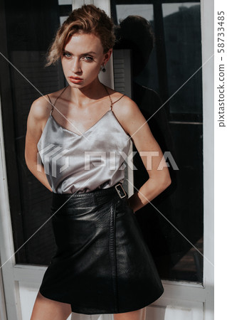 portrait of a beautiful fashionable woman on a dark background portrait of a beautiful fashionable woman on a dark background 58733485