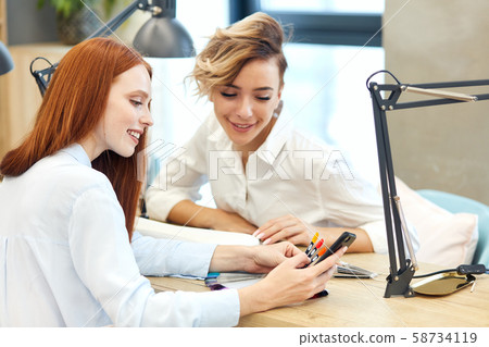 Redhead caucasian girl show manicure on phone Redhead caucasian girl show manicure on phone 58734119