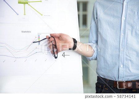 Midsection Of Businessman With Eyeglasses Giving Presentation 58734141