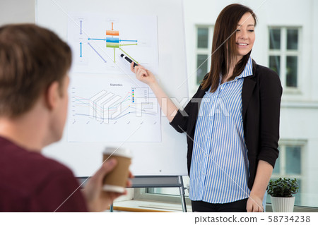 Businesswoman Looking Away While Giving Presentation 58734238