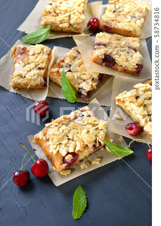 Yeast cake with fresh cherries  and crunchy almond caramel 58734816