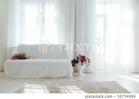 sofa with flowers in the interior of the white room of the house sofa with flowers in the interior of the white room of the house 58734884