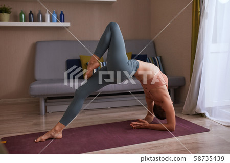Active young female doing yoga bridge Active young female doing yoga bridge 58735439