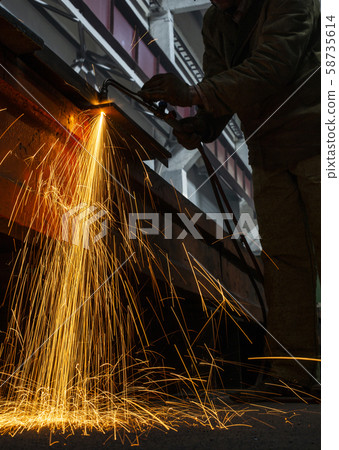 Industrial Worker at the factory welding closeup sparks light long exposure Industrial Worker at the factory welding closeup sparks light long exposure 58735614