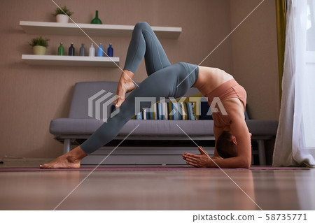 Active young female doing yoga bridge Active young female doing yoga bridge 58735771