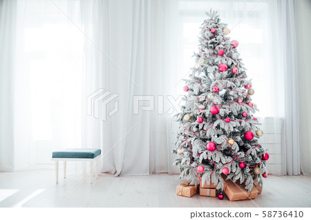 Christmas snowy Christmas tree with presents in a white room in winter 58736410
