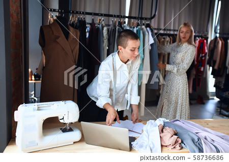 Young fashion designer draw new sketches collection on laptop Young fashion designer draw new sketches collection on laptop 58736686