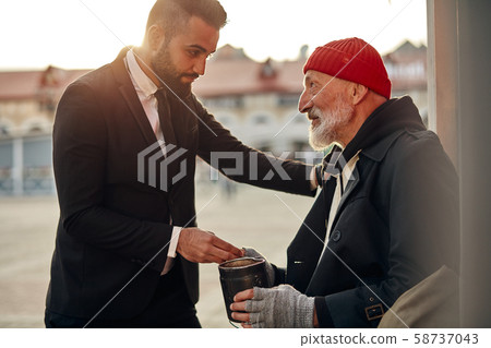 Rich man help senior beggar 58737043