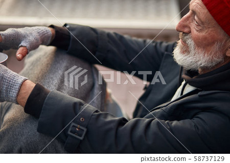 Close-up homeless person waiting help. Unemployed beggars live on street Close-up homeless person waiting help. Unemployed beggars live on street 58737129