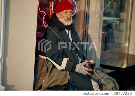 mature beggar man sitting in the center of city asking for money mature beggar man sitting in the center of city asking for money 58737280