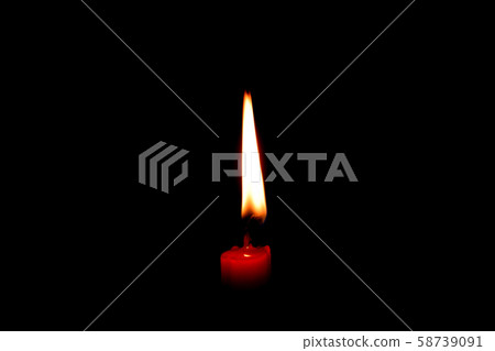 light flame candle burning brightly on black background 58739091