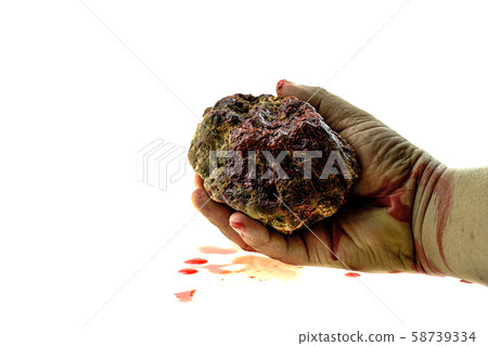 Close up hand is holding stone bloody at white background Close up hand is holding stone bloody at white background 58739334