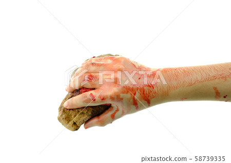 Close up hand is holding stone bloody at white background Close up hand is holding stone bloody at white background 58739335