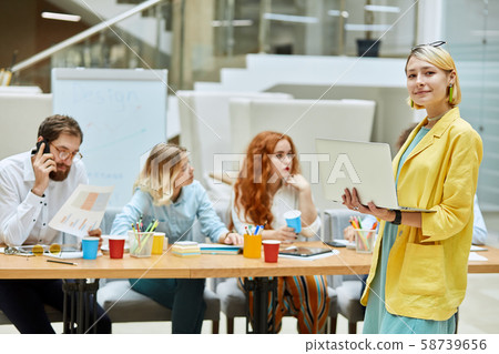 Cheerful designers working in modern agency Cheerful designers working in modern agency 58739656