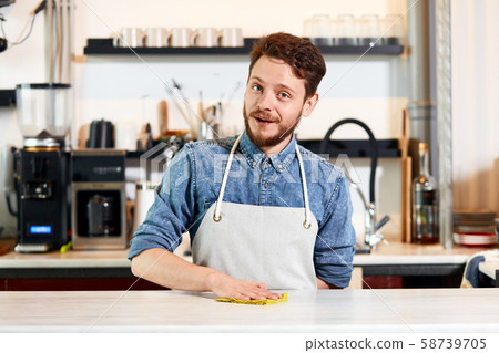 Confident self assured barista at bar counter Confident self assured barista at bar counter 58739705