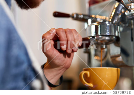 Skillful male barista working hard at counter Skillful male barista working hard at counter 58739758