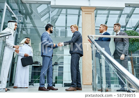 Sheikh and caucasian businessman shaking hands Sheikh and caucasian businessman shaking hands 58739855
