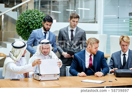 Sheikhs on business meeting with caucasians Sheikhs on business meeting with caucasians 58739897