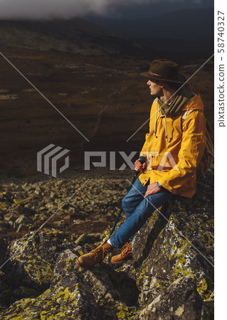 young romantic tourist dreaming while leaning on the stone 58740327