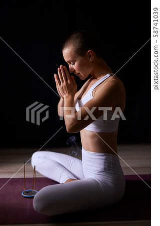 Padmasana, lotus pose, namaste. Woman pray with aroma sticks 58741039