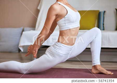 Portrait of fit short-haired woman doing exercise at home 58741354