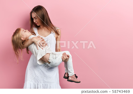 woman holding her sick pale oor daughet in hands going to visit doctor, hospital woman holding her sick pale oor daughet in hands going to visit doctor, hospital 58743469