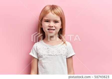 Little cute girl clenching her teeth 58743623