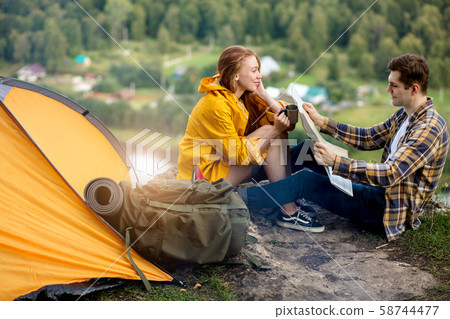 young man and woman preparing for travel young man and woman preparing for travel 58744477