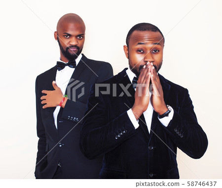 two afro-american businessmen in black suits emotional posing, gesturing, smiling. wearing bow-ties 58746437