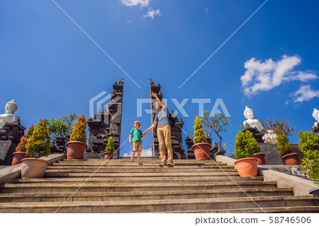Dad and son tourists in budhist temple Brahma Vihara Arama Banjar Bali, Indonesia. Honeymoon Dad and son tourists in budhist temple Brahma Vihara Arama Banjar Bali, Indonesia. Honeymoon 58746506